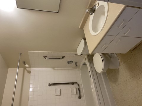 A white bathroom with a toilet and a shower.
