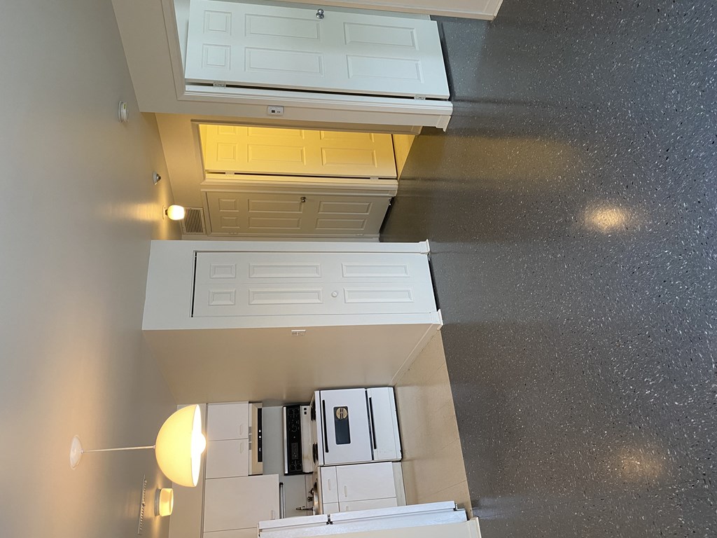 A view of a kitchen from above, showing a white cabinet and a white ceiling.