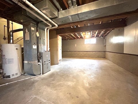 a large room with a concrete floor and pipes in it