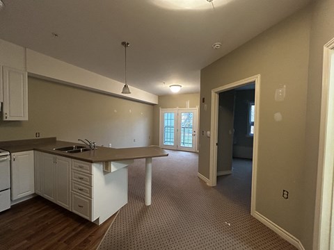 an empty kitchen and living room in an empty house