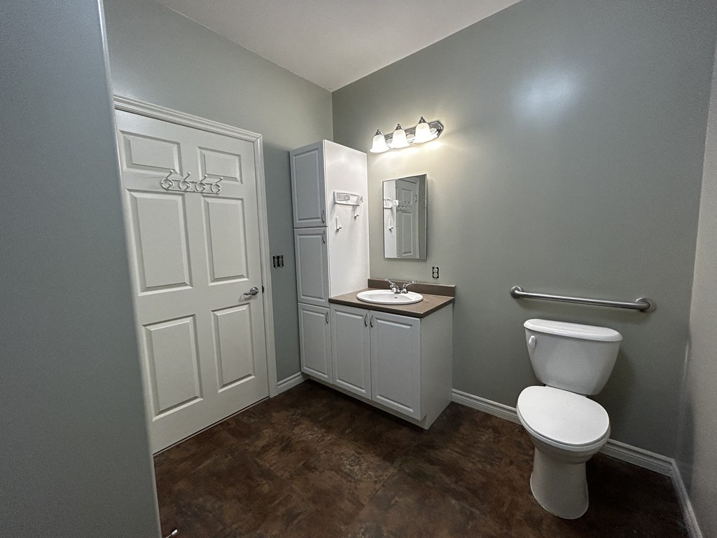 an empty bathroom with a toilet and a sink