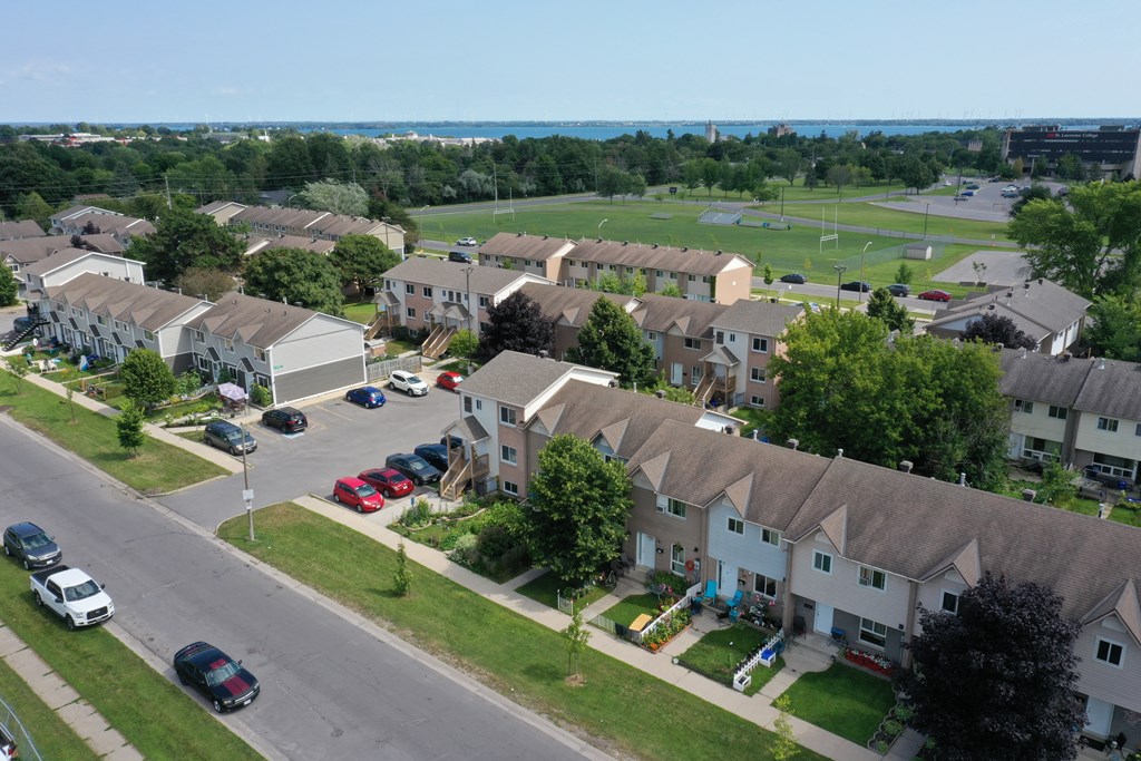 A residential area with houses and cars.