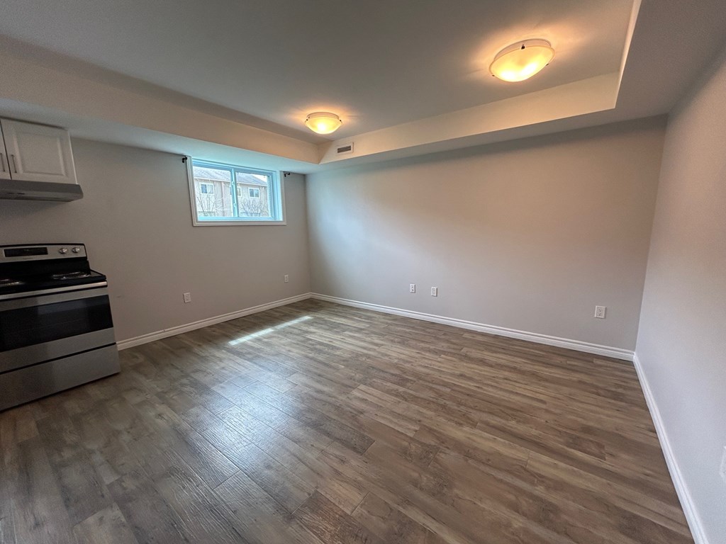 A kitchen with a stove top oven and a window.