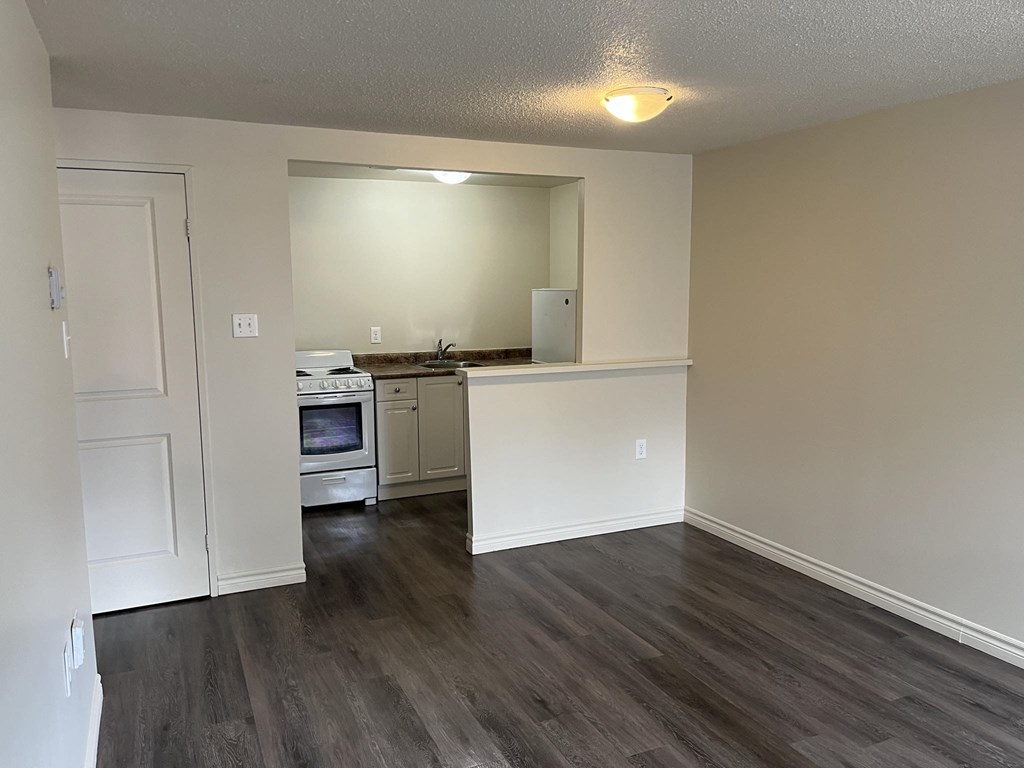 A kitchen with a white countertop and a white oven.