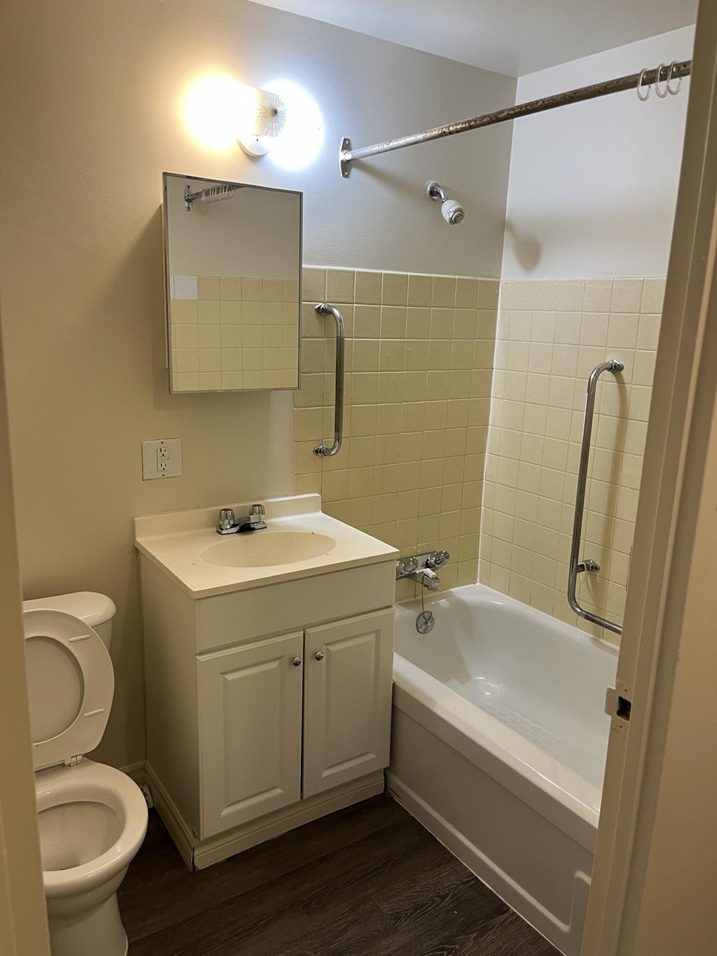 A white toilet sits next to a sink in a small bathroom.
