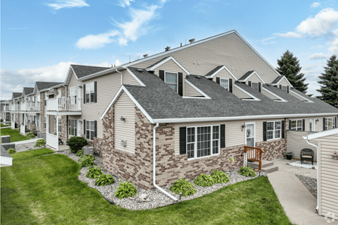 A house with a brown brick facade and a grey roof.