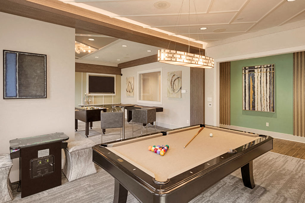 Billiard and gaming room with billiard table, Foosball and chairs