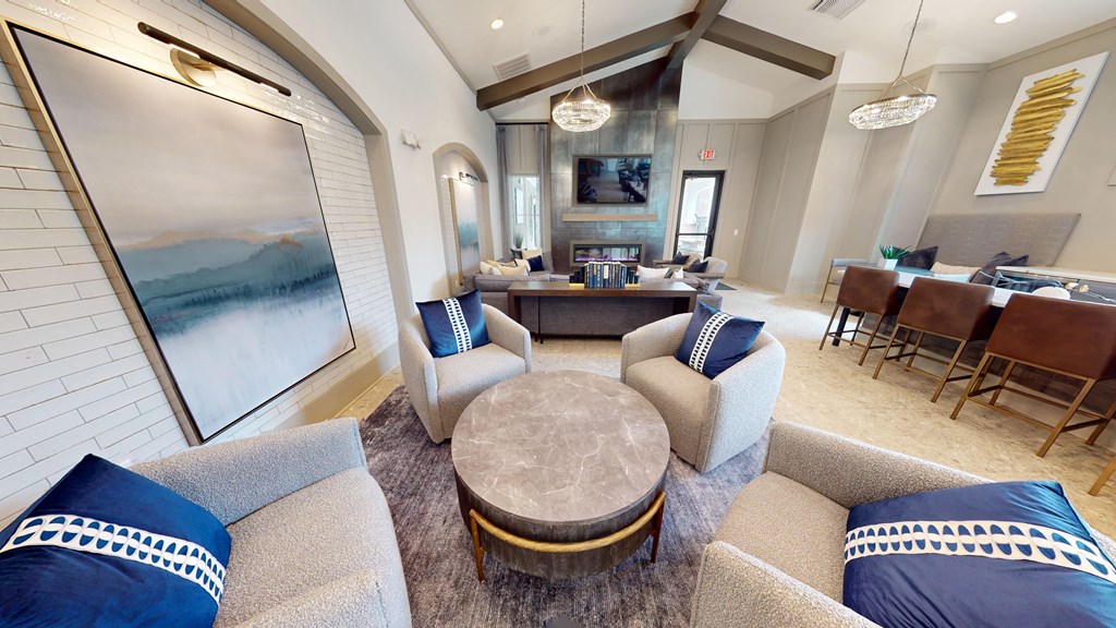 a living room with couches and chairs and a table