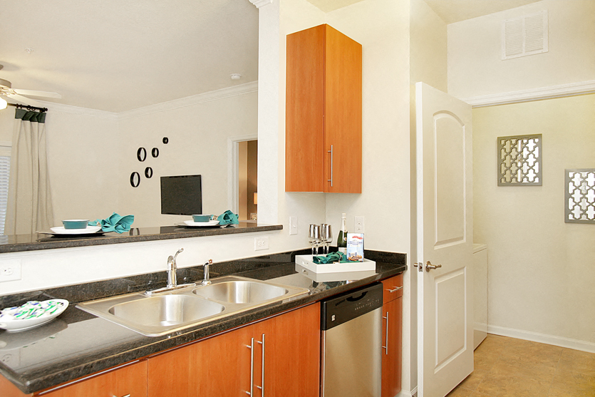 Kitchen with stainless steel appliances; open to living room