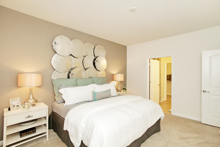 Bedroom with carpet; door to in-room bathroom and closet