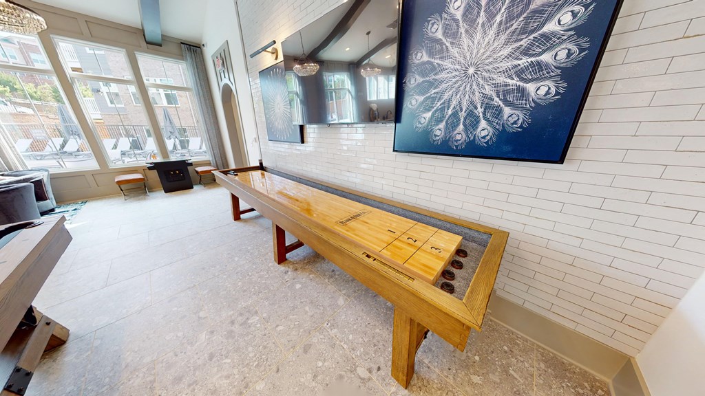 a wooden bench in a room with a painting on the wall
