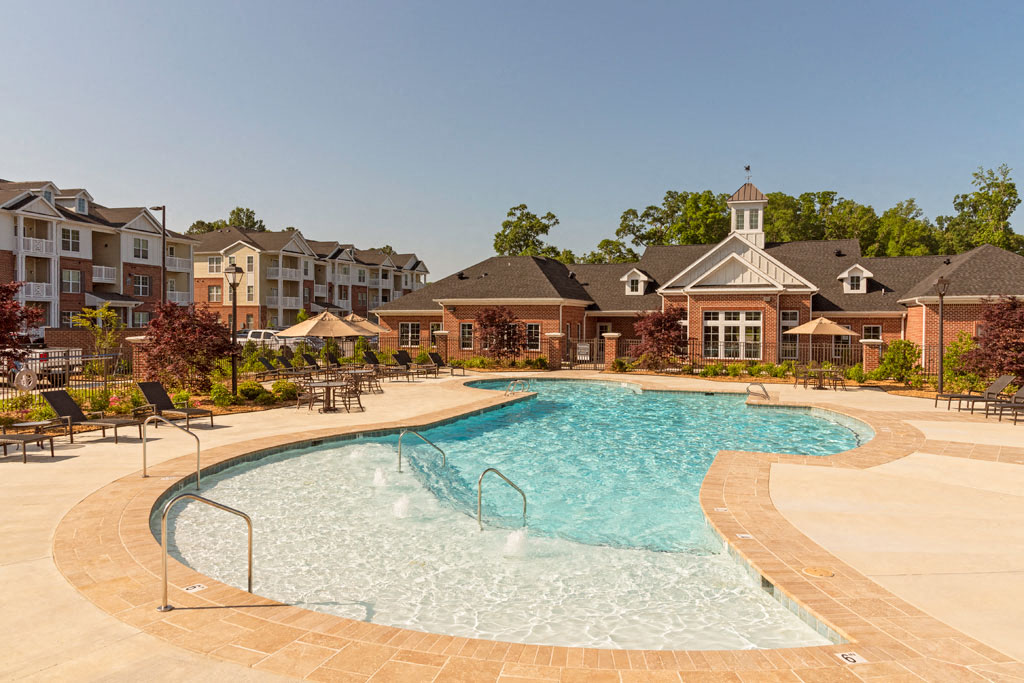 Resort-style saltwater pool with chairs and umbrellas