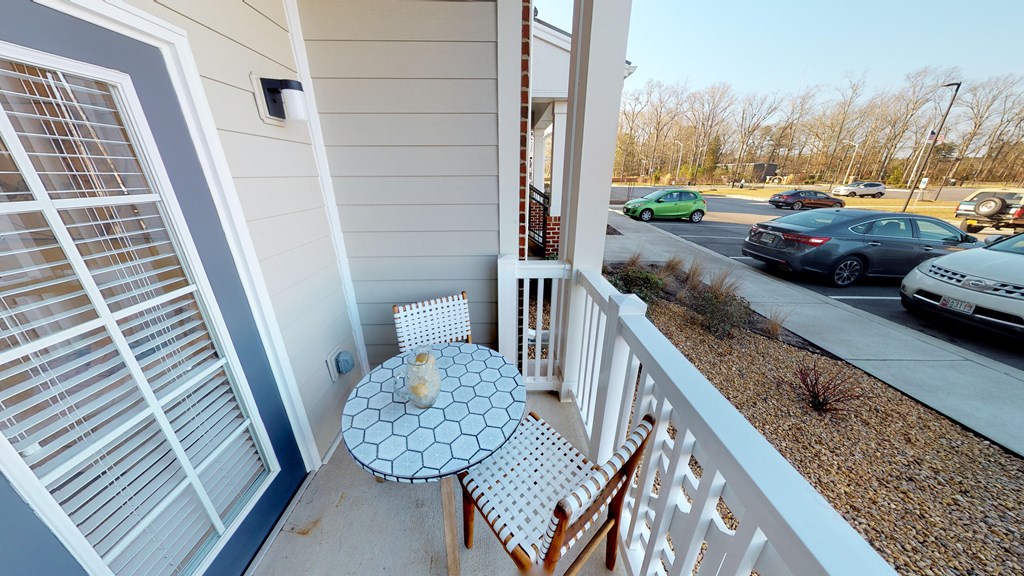 Private patio off the living room with table and two chairs