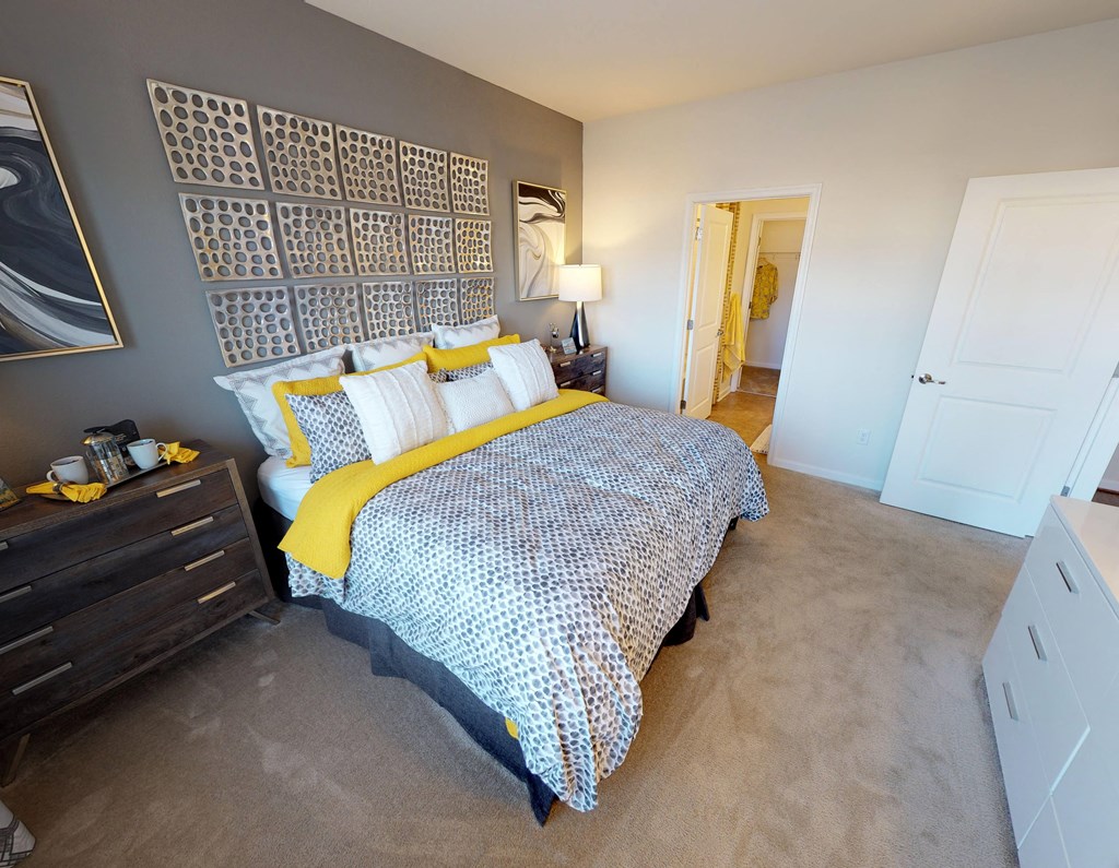 Bedroom with carpet; door to bathroom and closet