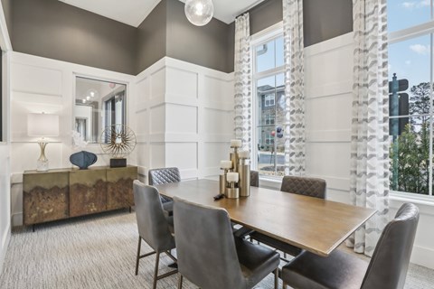 a private conference room with a table, seating and television