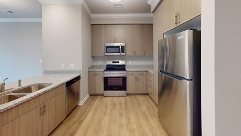 A kitchen with a refrigerator on the right side.