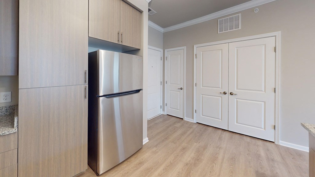 a kitchen with a stainless steel refrigerator and white doors