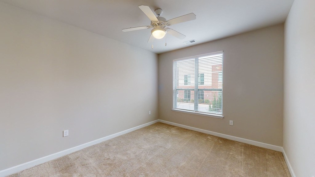 Bedroom with ceiling fan, carpet, window