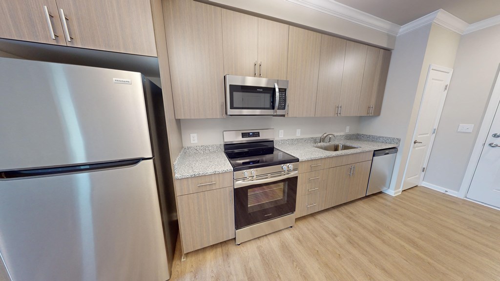a kitchen with stainless steel appliances and wooden cabinets