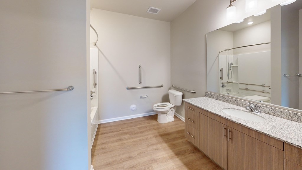 a bathroom with a shower toilet and sink and a mirror