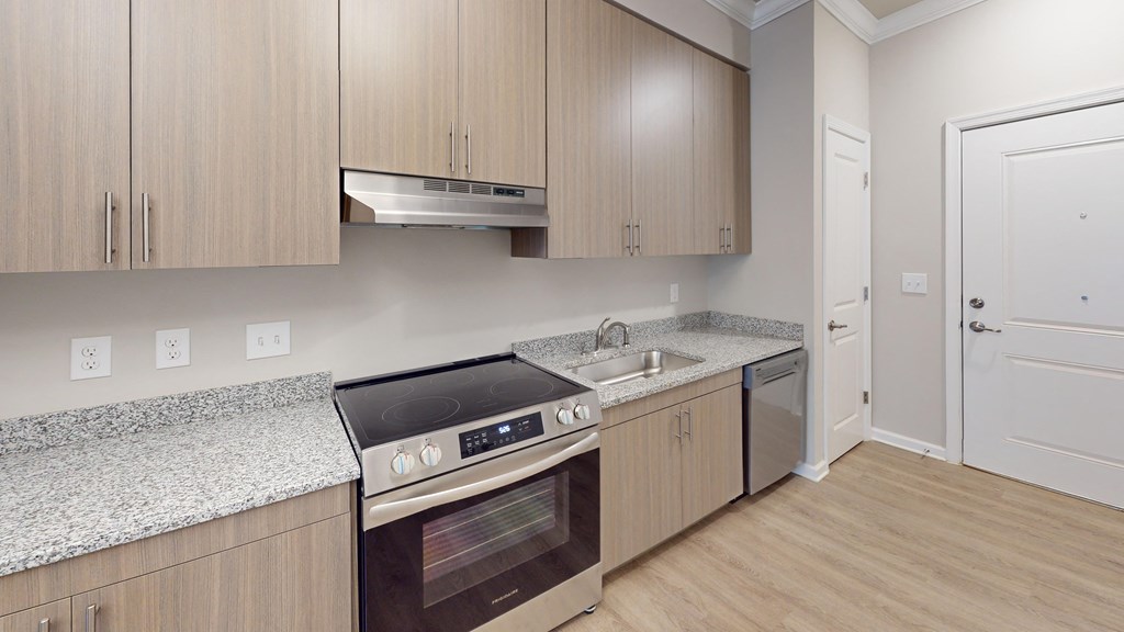 a kitchen with wooden cabinets and stainless steel appliances