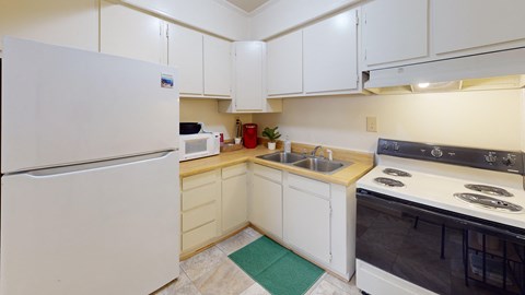 a full-size kitchen with a refrigerator