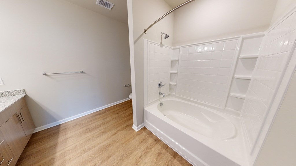 a bathroom with a shower and a sink and a toilet