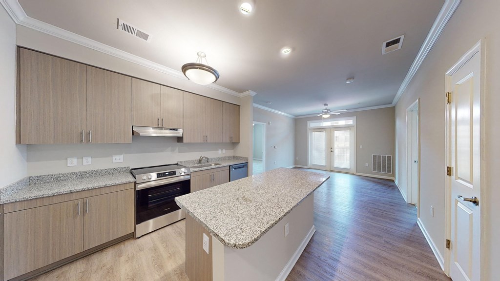 a kitchen with wood flooring and granite counter tops