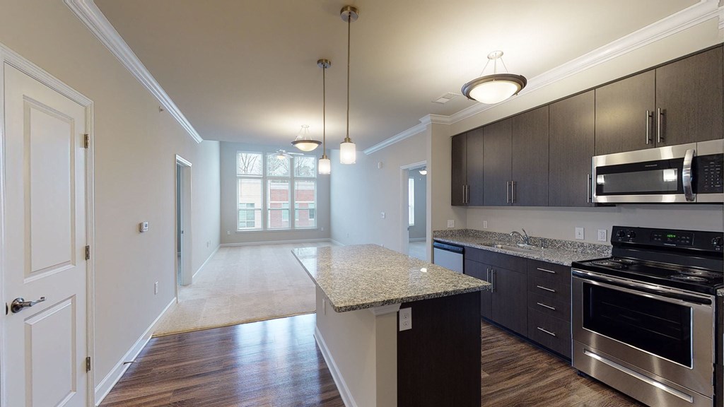 Kitchen with island open to the main living area with sunroom