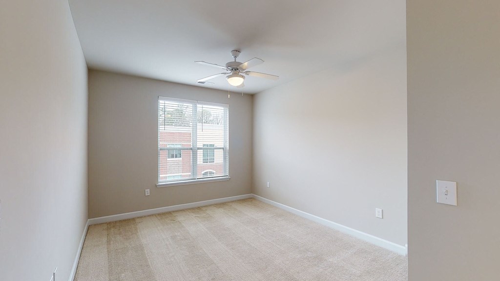 Bedroom with ceiling fan, carpet and window