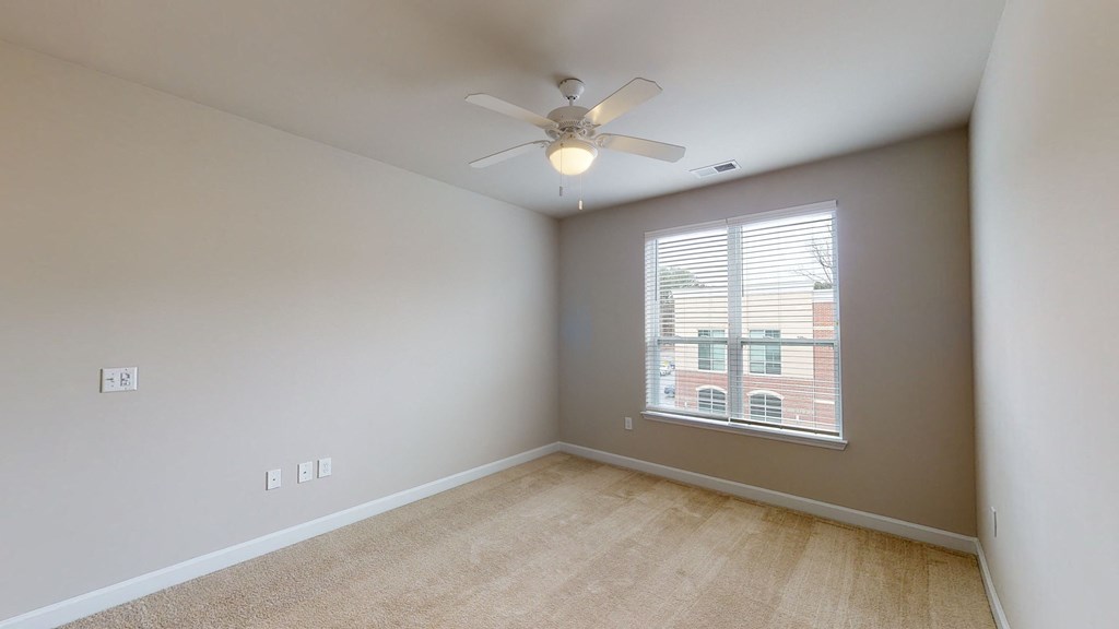 Bedroom with ceiling fan, carpet and window