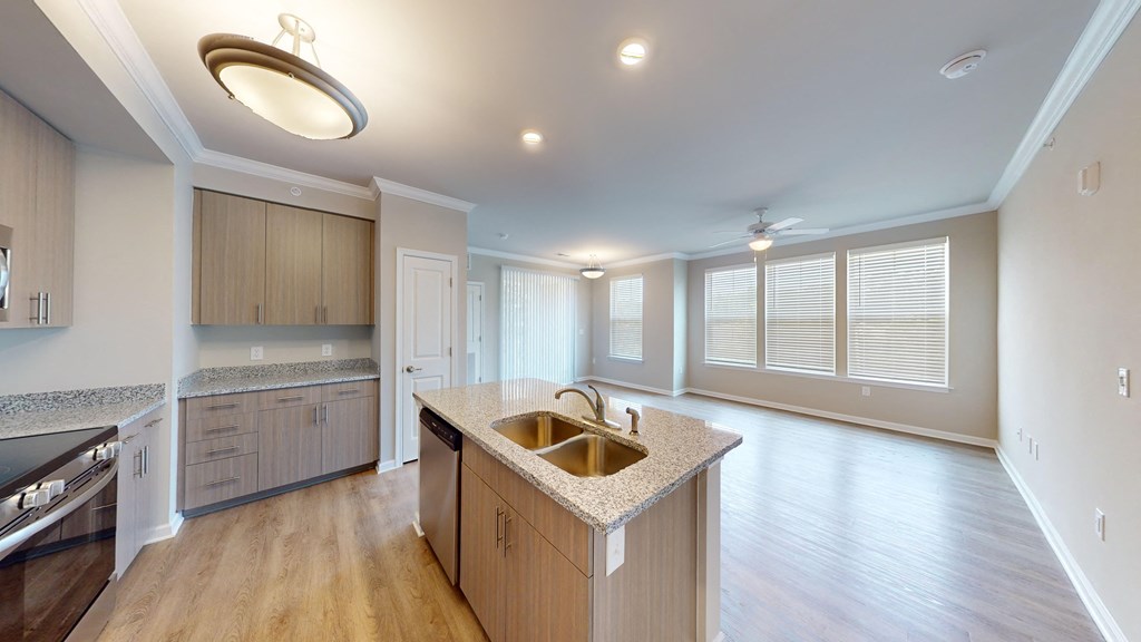 an open kitchen and living room with a large window