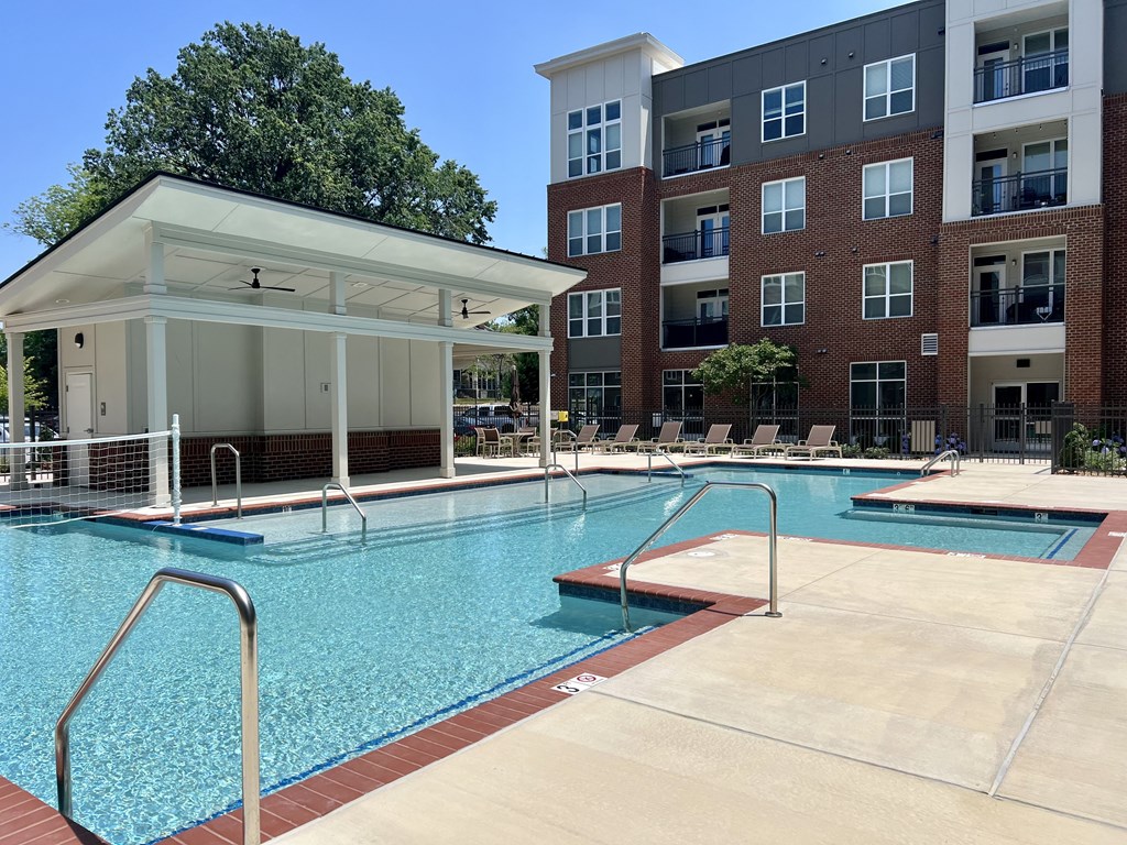 a swimming pool with a building in the background