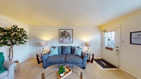 A living room with a grey couch and a coffee table.