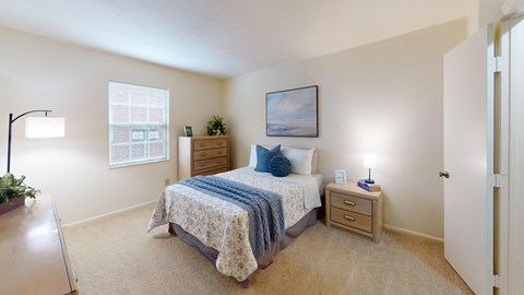 a bedroom with a window and walk-in closet