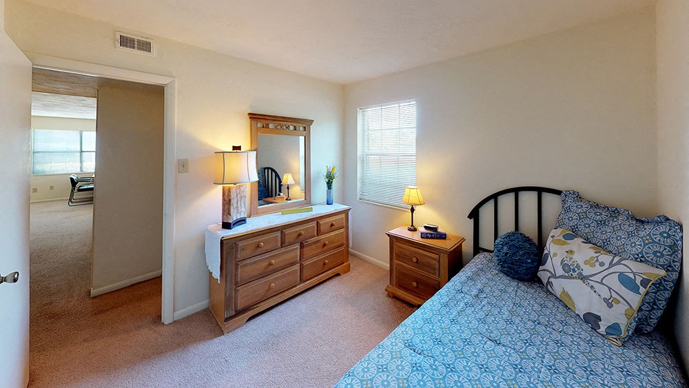 a bedroom with a bed and a mirror