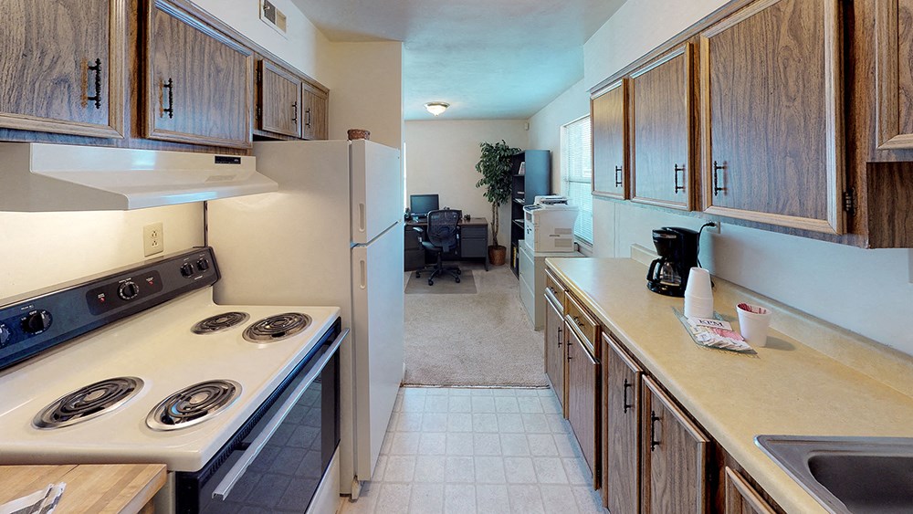 a kitchen with a stove and a refrigerator