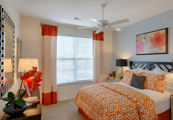 Bedroom with ceiling fan, carpet and window