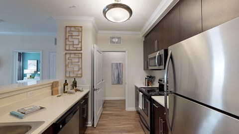 a kitchen with stainless steel appliances and a counter top