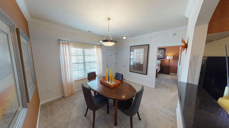 a dining room and living room with a table and chairs