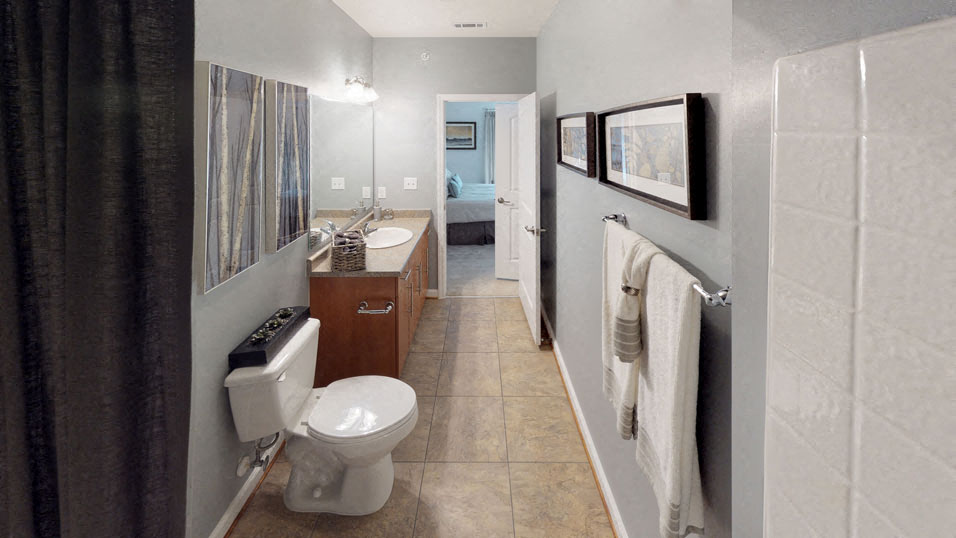 Bathroom in bedroom with bathtub, toilet, sink