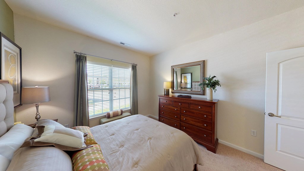 Bedroom with window; carpet