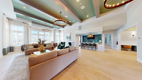A living room with a long couch and a fireplace.