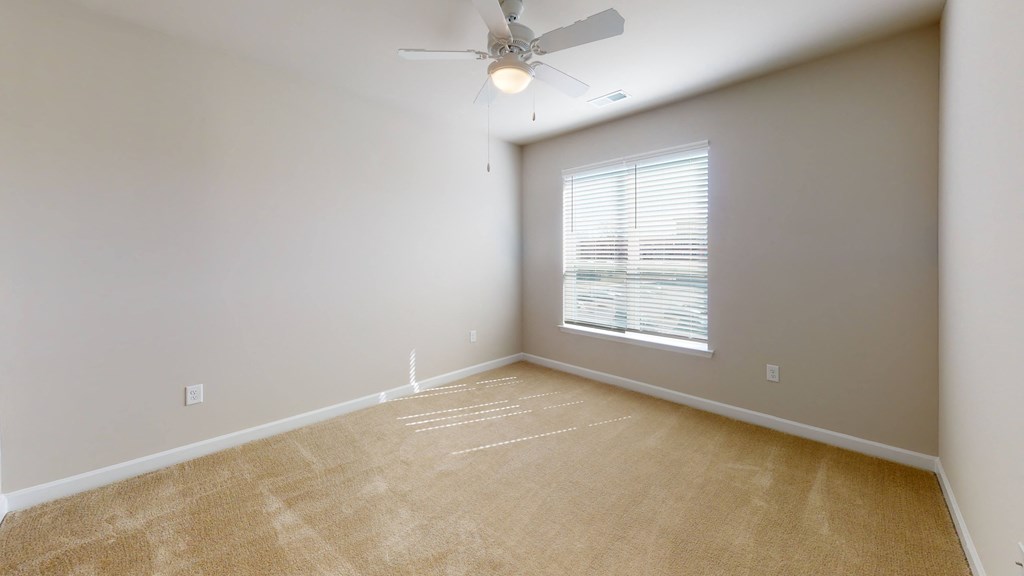 Bedroom with ceiling fan, carpet and window