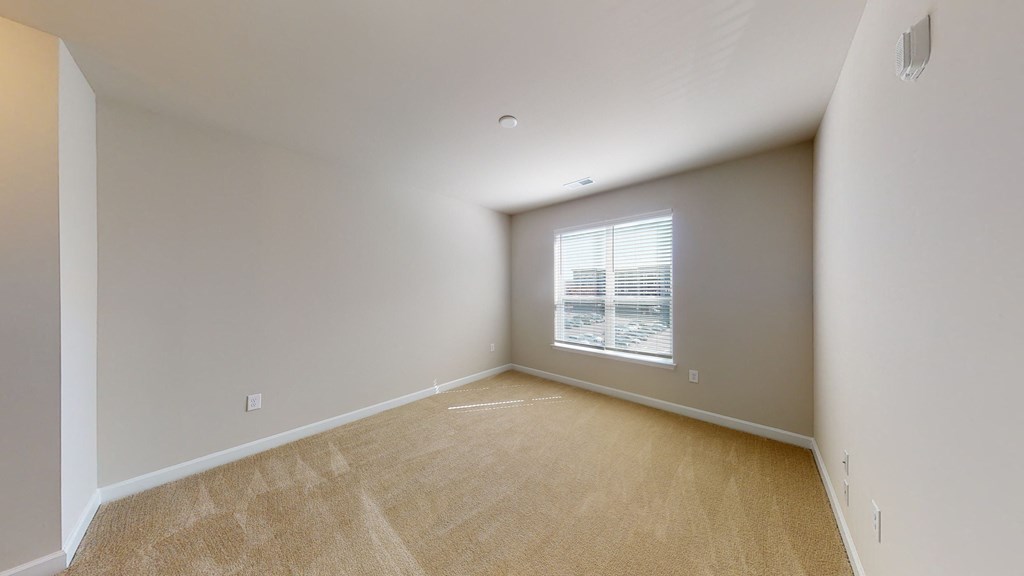 Bedroom with window; carpet
