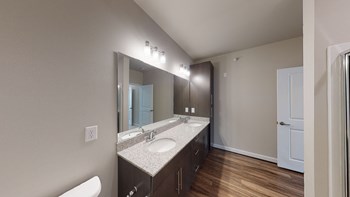 Bathroom with dual sinks, dark cabinets, toilet and walk-in shower - Photo Gallery 59
