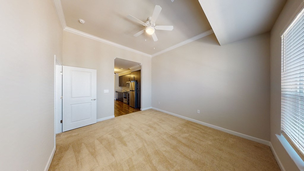 Living room with carpet; ceiling fan; open to ktichen