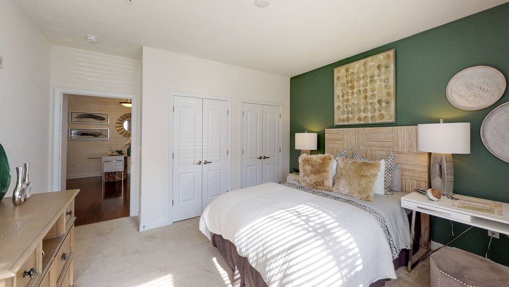 Bedroom with closet and carpet; hallway bathroom