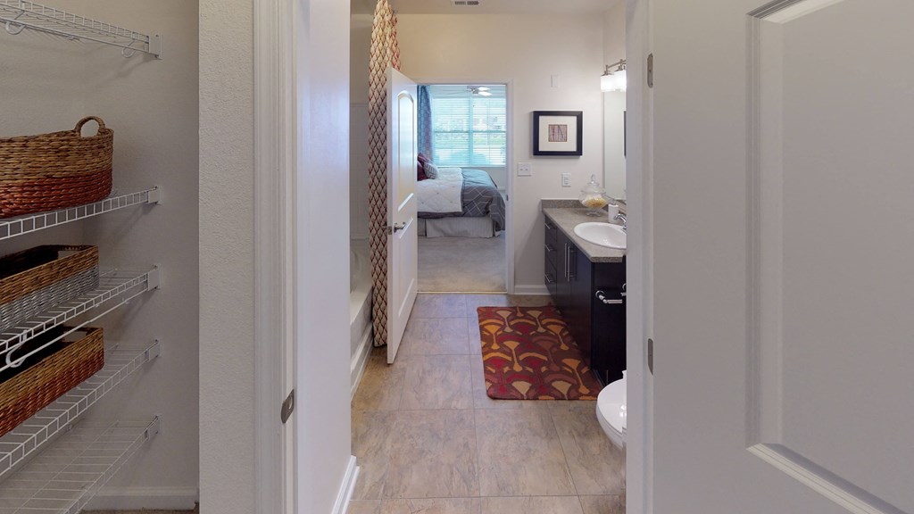 Walk-in closet leading into bathroom; inside main bedroom
