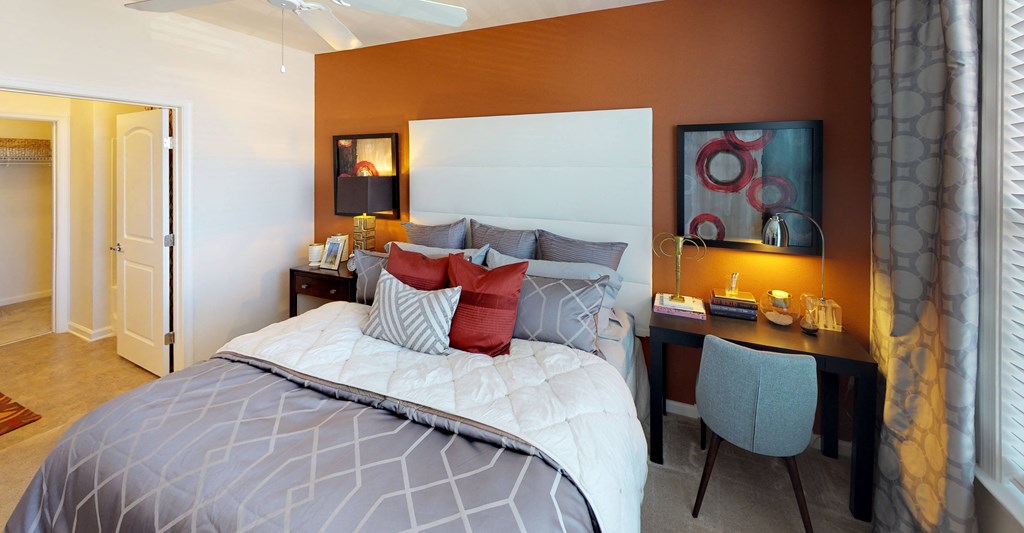 Bedroom with carpet; door to bathroom